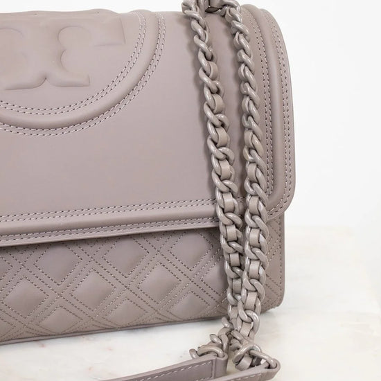Gray quilted handbag with a chain strap on a white background