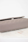 Quilted clutch bag on a light surface