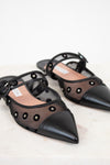 Black pointed-toe shoes with mesh design on a light background