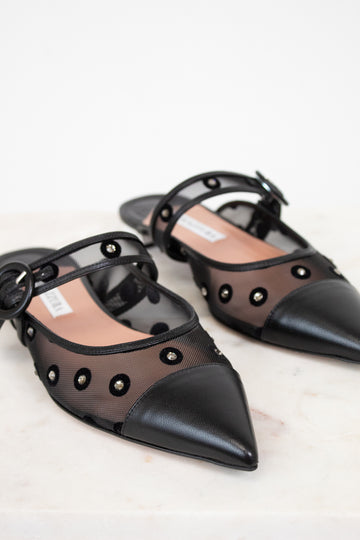 Black pointed-toe shoes with mesh design on a light background