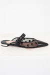 Black sandal with decorative elements on a white background