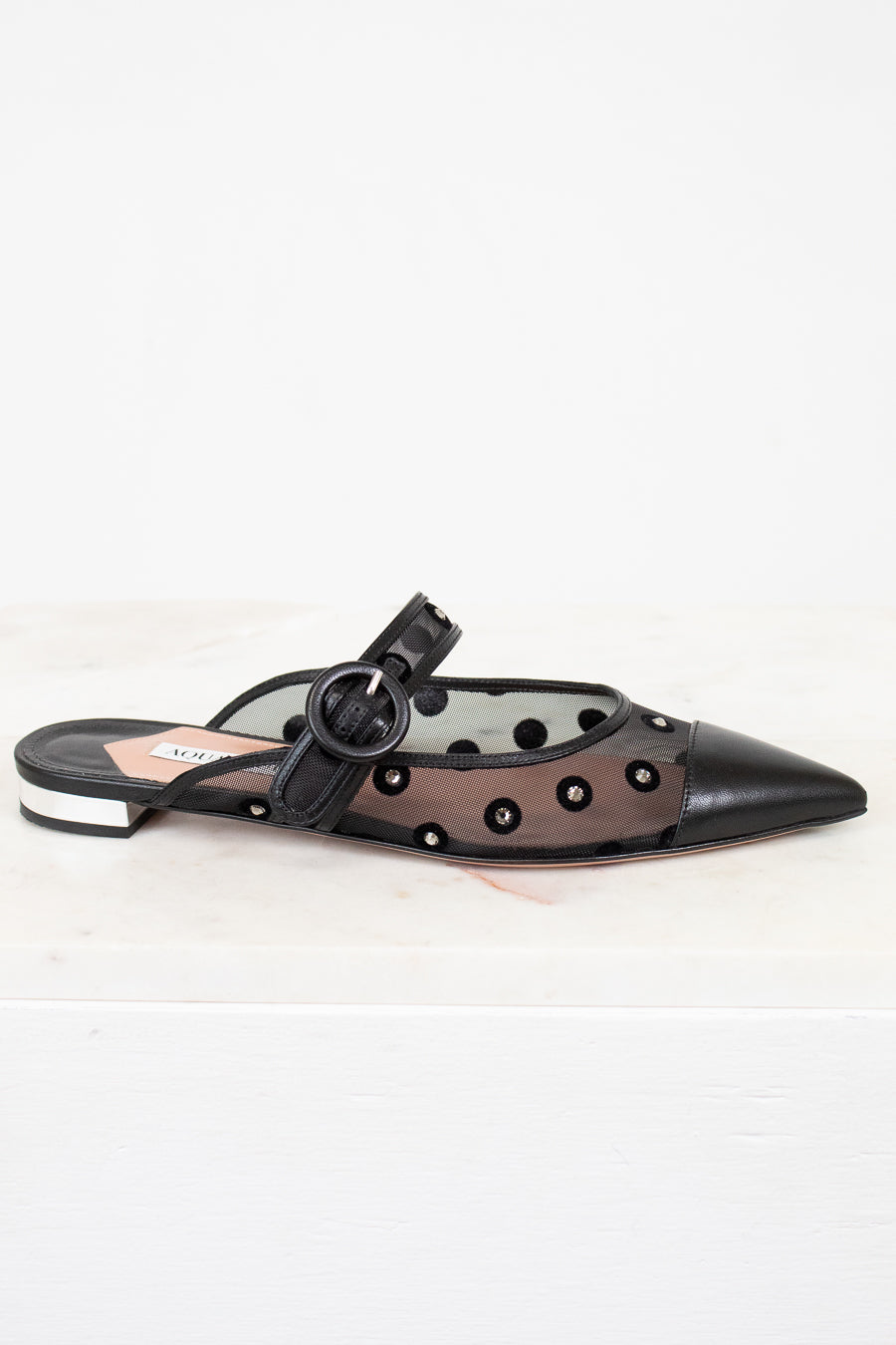 Black sandal with decorative elements on a white background